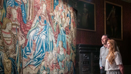 Visitors with the Queen Esther tapestry at Oxburgh Estate